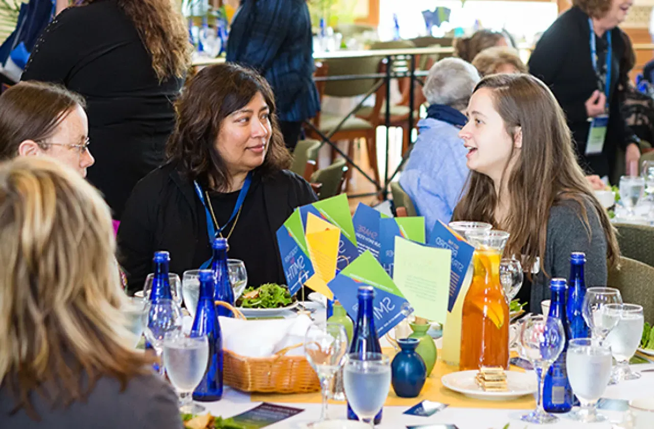 Alumnae volunteers sitting around a table